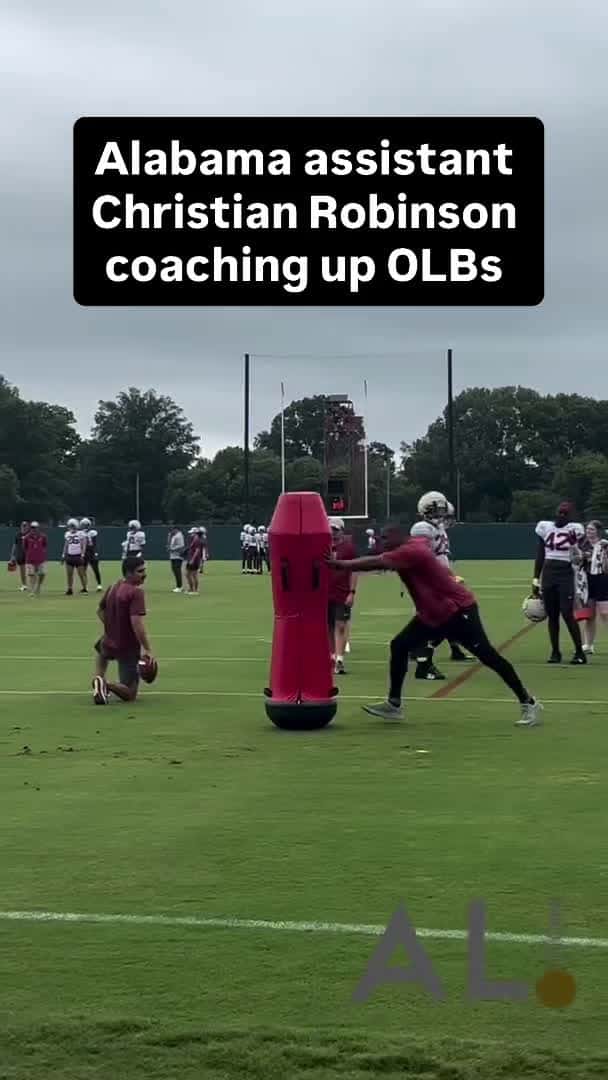 Cover for Alabama assistant coach Christian Robinson works with the Wolves aka outside linebackers during practice on Sunday