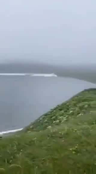 Cover for A man walking his dog caught on camera the moment tsunami waves crashed onto Russia’s Kamchatka Peninsula.