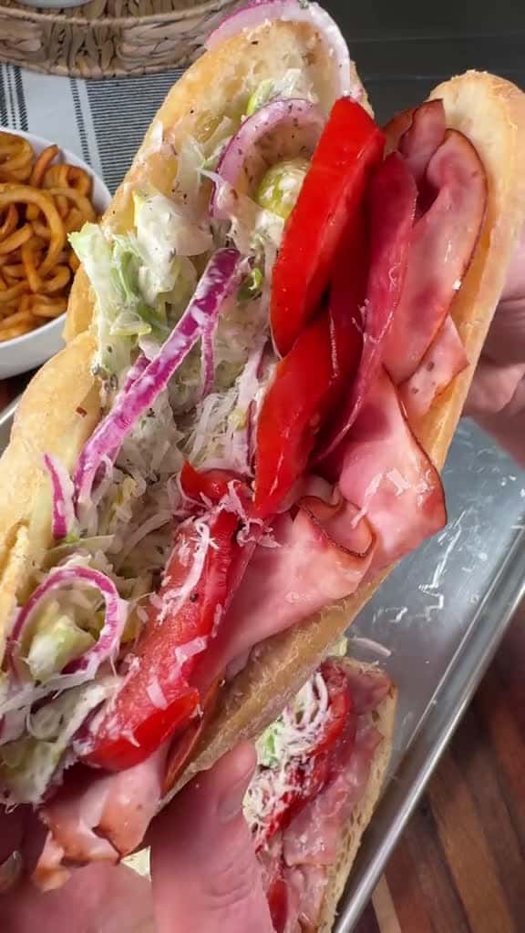 Cover for Grinder Salad Sandwiches are our go to easy dinner when we can’t decide what to have!  INGREDIENTS Hoagie Rolls Ham Salami Pepperoni  Provolone  1/2 cup of mayo 2 tbsp of red wine vinegar 1/2 tsp of salt and pepper  1 tsp of dr...