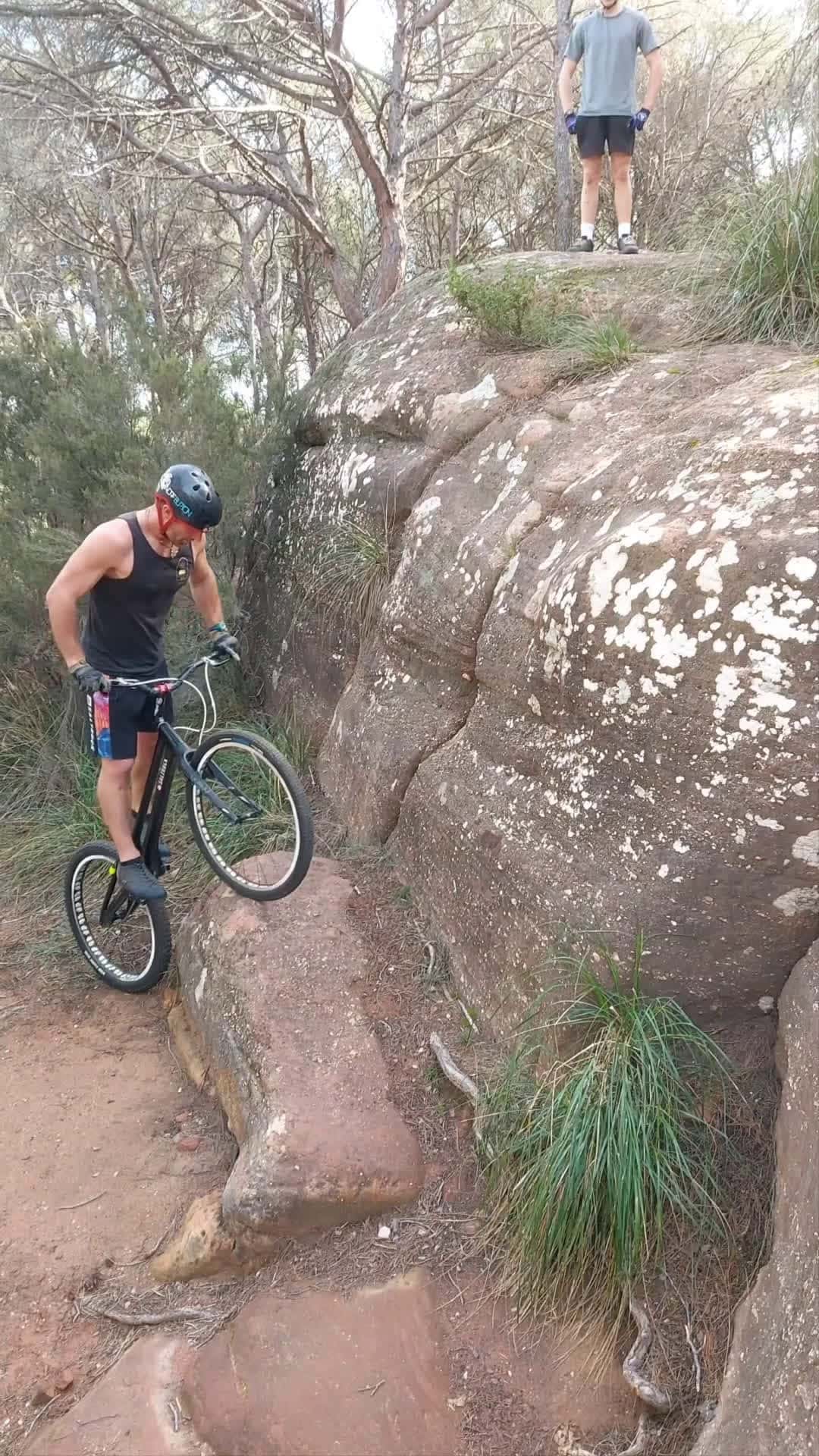 Cover for Cyclist jumps his trails bike up a rock face