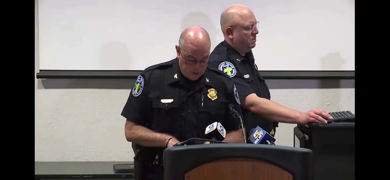 Cover for Police Chief Brian Valenti reads a “Use of Force” report and shows body cam footage from the officer who repeatedly punched a man in a red hat during a protest in Cincinnati