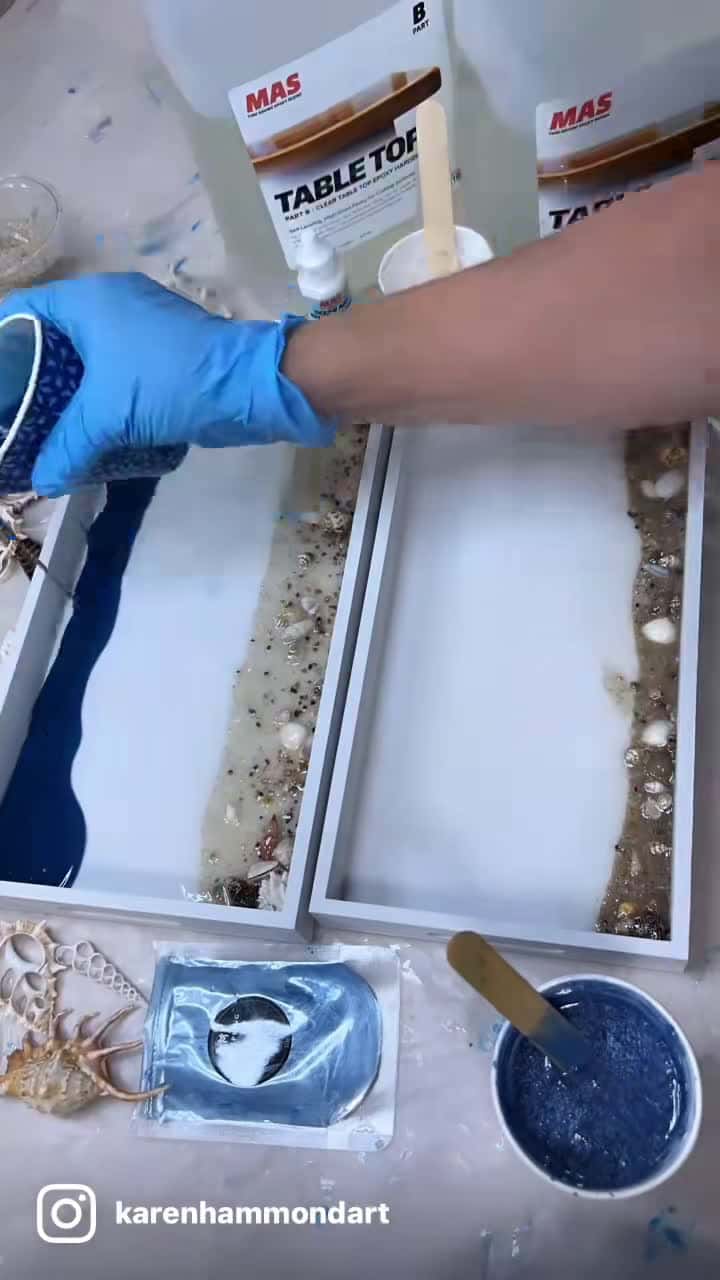 Cover for Pouring waves in a couple of beach trays. .  I am using MAS Epoxies Tabletop Epoxy and Ocean Art Resin Pigment white for my waves.  I recommend that you give it a try. There is a link in my bio. Use my code KAREN for MAS Epoxy order. 🌊🌊💙💙💙  . I’m also using Meyspring Pigment powders Calcite Blue! One of my favorite colors. Link in my bio for them. Use my discount code KARENSAVE. 🙏💙  . . . #karenhammondart #waveart #oceanpigment #beachtray #beachart #beachartist #resinart #resin #resinarti
