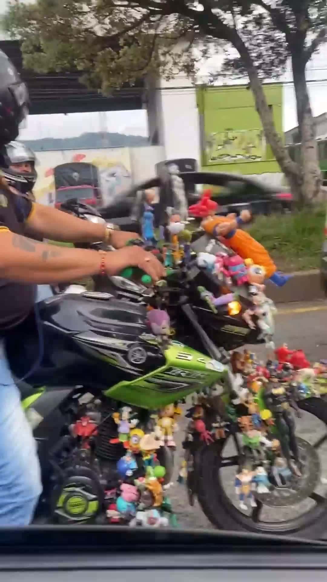 Cover for Mans Motorbike Covered In Toys