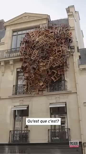 Cover for Dozens of Chairs Hang From Building in P