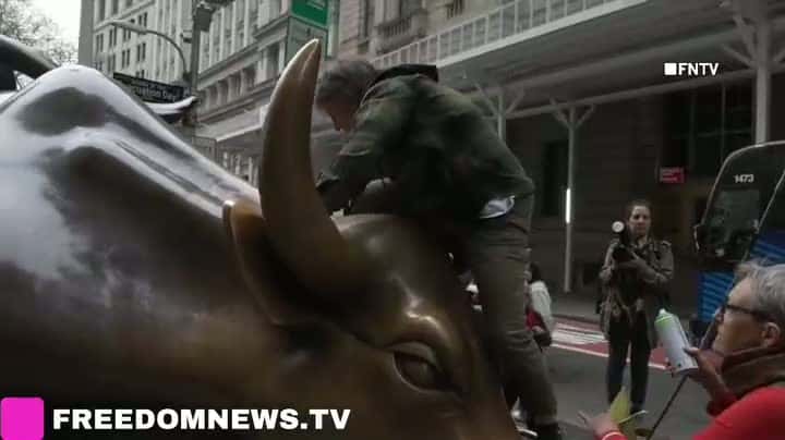 Cover for April 22 2025 MANHATTAN, New York - "Greed=Death" tagged on the Charging Bull in NYSE by Climate activists with Extinction Rebellion, on the National Earth Day.After defacing Charging Bull statue with chalk spray, climate acti...