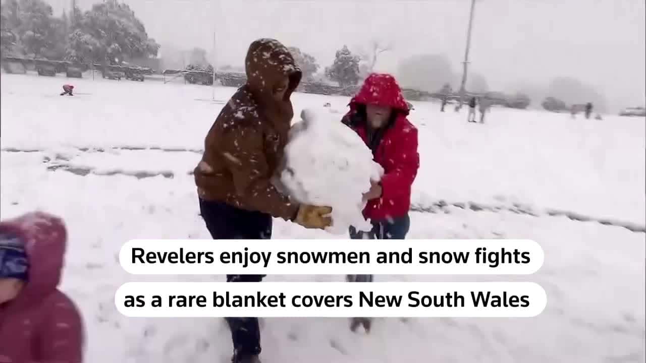 Cover for Locals and visitors made the most of rare snow in New South Wales, Australia, enjoying snowball fights, building snowmen and taking photos 