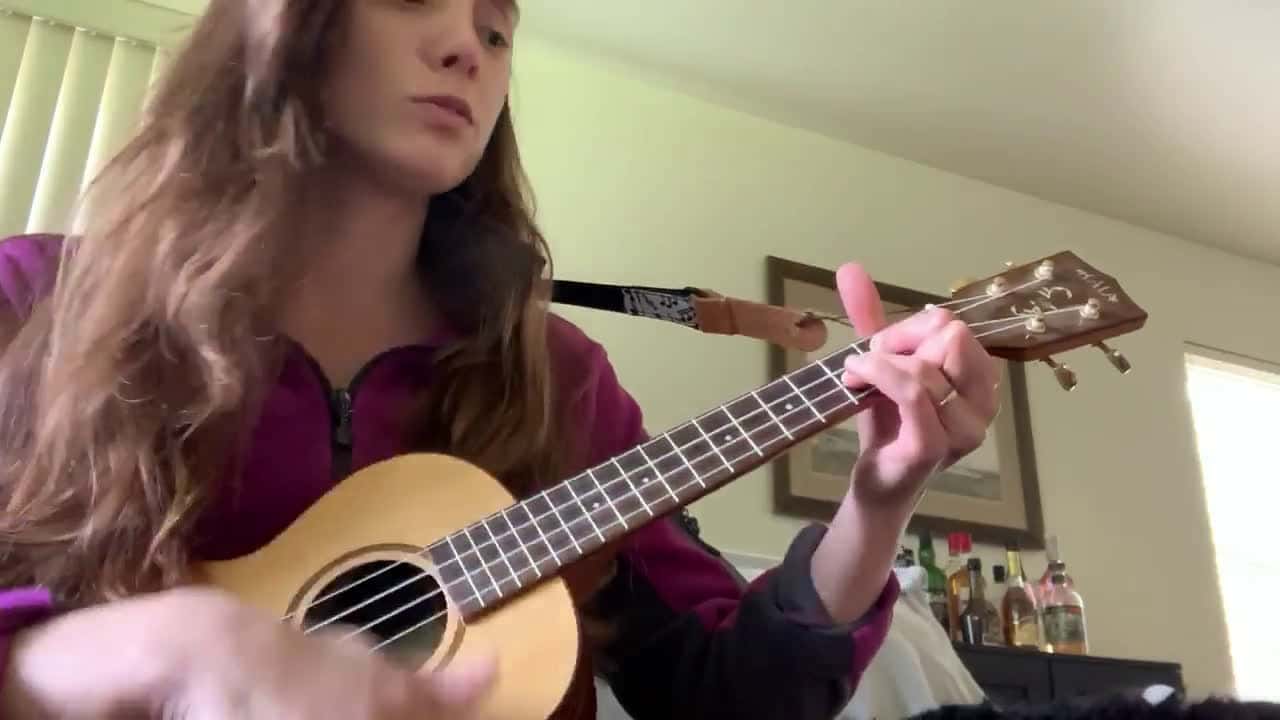 Cover for Woman playing ukulele beside the dog