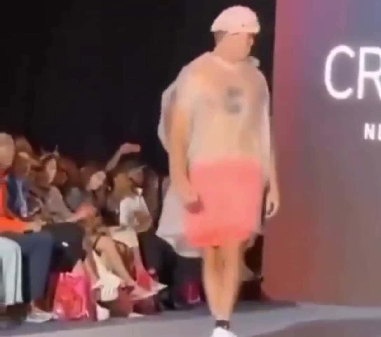 Cover for Man walks into fashion show with garbage bag on