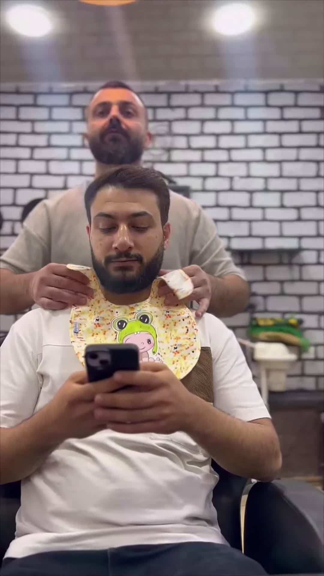 cover for #OddlySatisfying Lighthearted Barber Pranks Clients With Baby Bib.