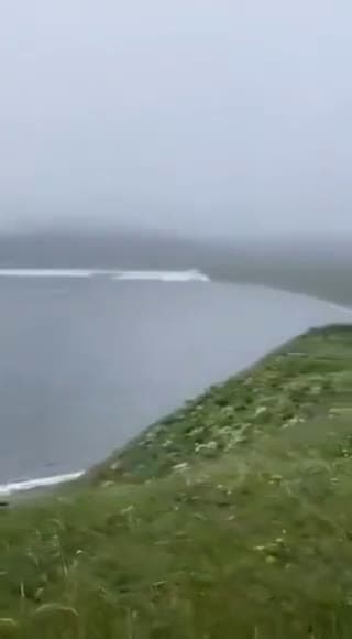 cover for A man walking his dog caught on camera the moment tsunami waves crashed onto Russia’s Kamchatka Peninsula.
