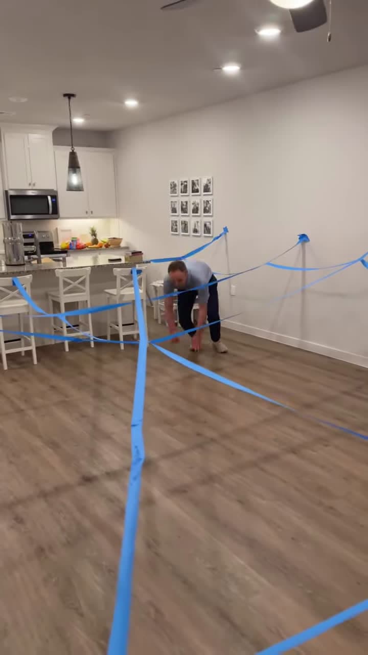cover for Dad uses painters tape to turn the house into an obstacle course
