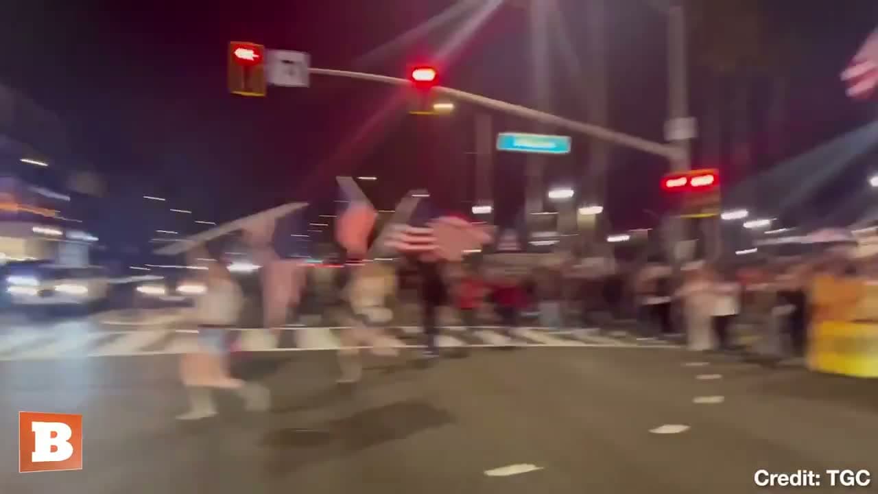 cover for A large crowd gathers waving American flags to honor Charlie Kirk at the Huntington Beach Pier in California