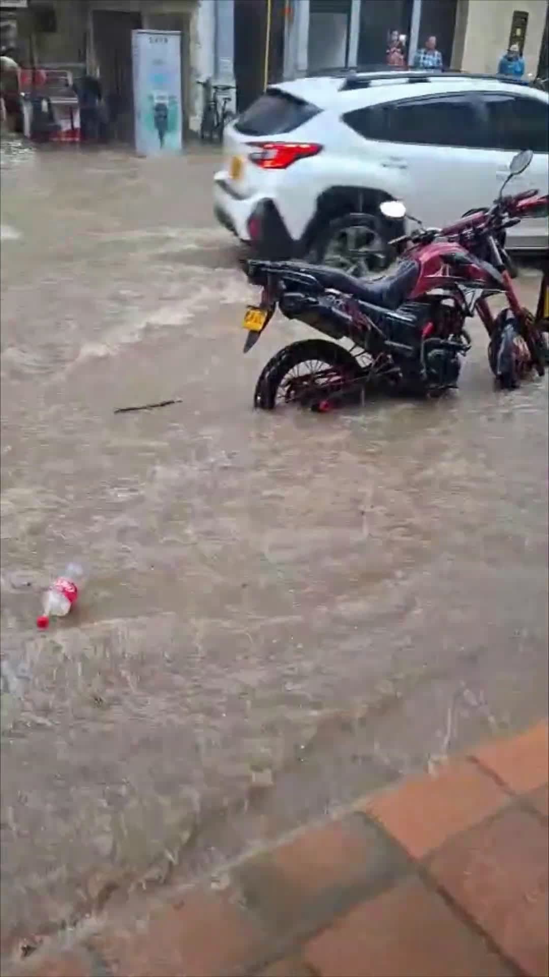cover for Biker Tumbles on Flooded Street