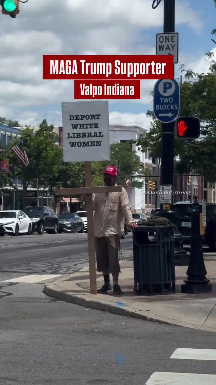 cover for MAGA Supporter Trolls Protesters in Indiana With Sign: “Deport White Liberal Women”
