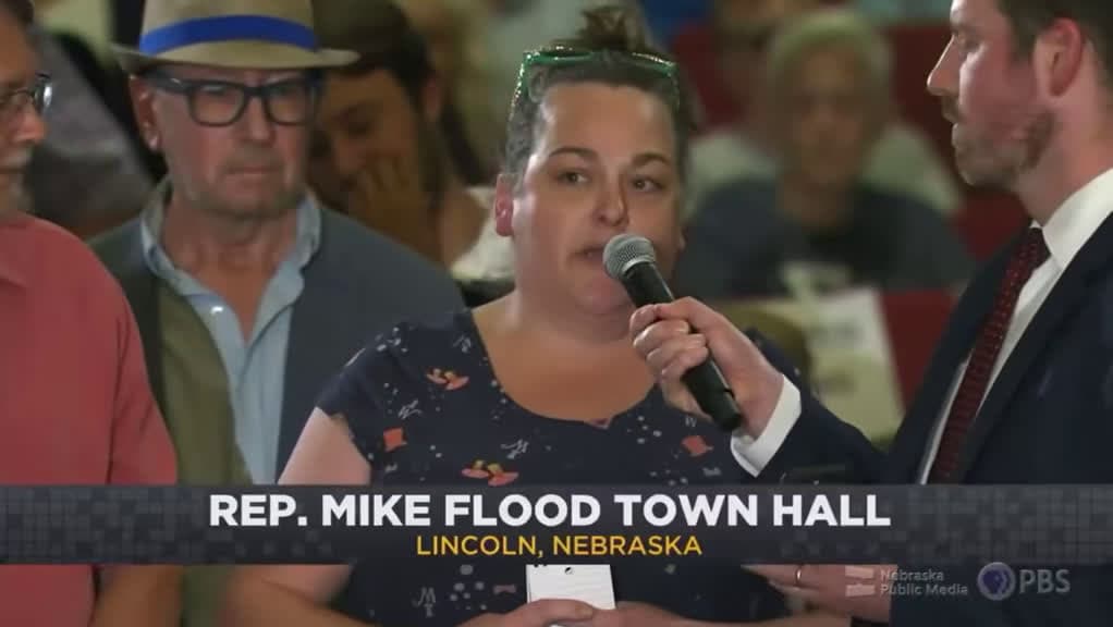 cover for Rep. Mike Flood grilled at town hall over support for Trump policies—attendee slams tax dollars spent on ICE and 'fascism.' Lincoln crowd erupts. #Politics #Nebraska #TownHall