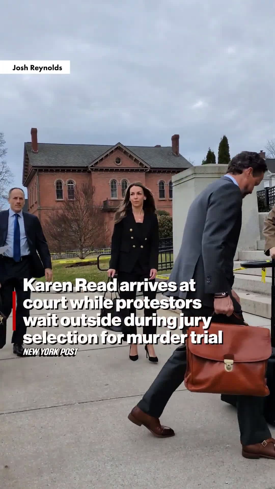cover for Karen Read arrives at court while protestors wait outside during jury selection for murder trial